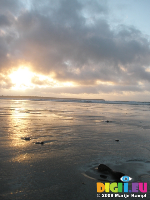 JT00132 Sunrise over pebble on Tramore beach (Brownstown head)